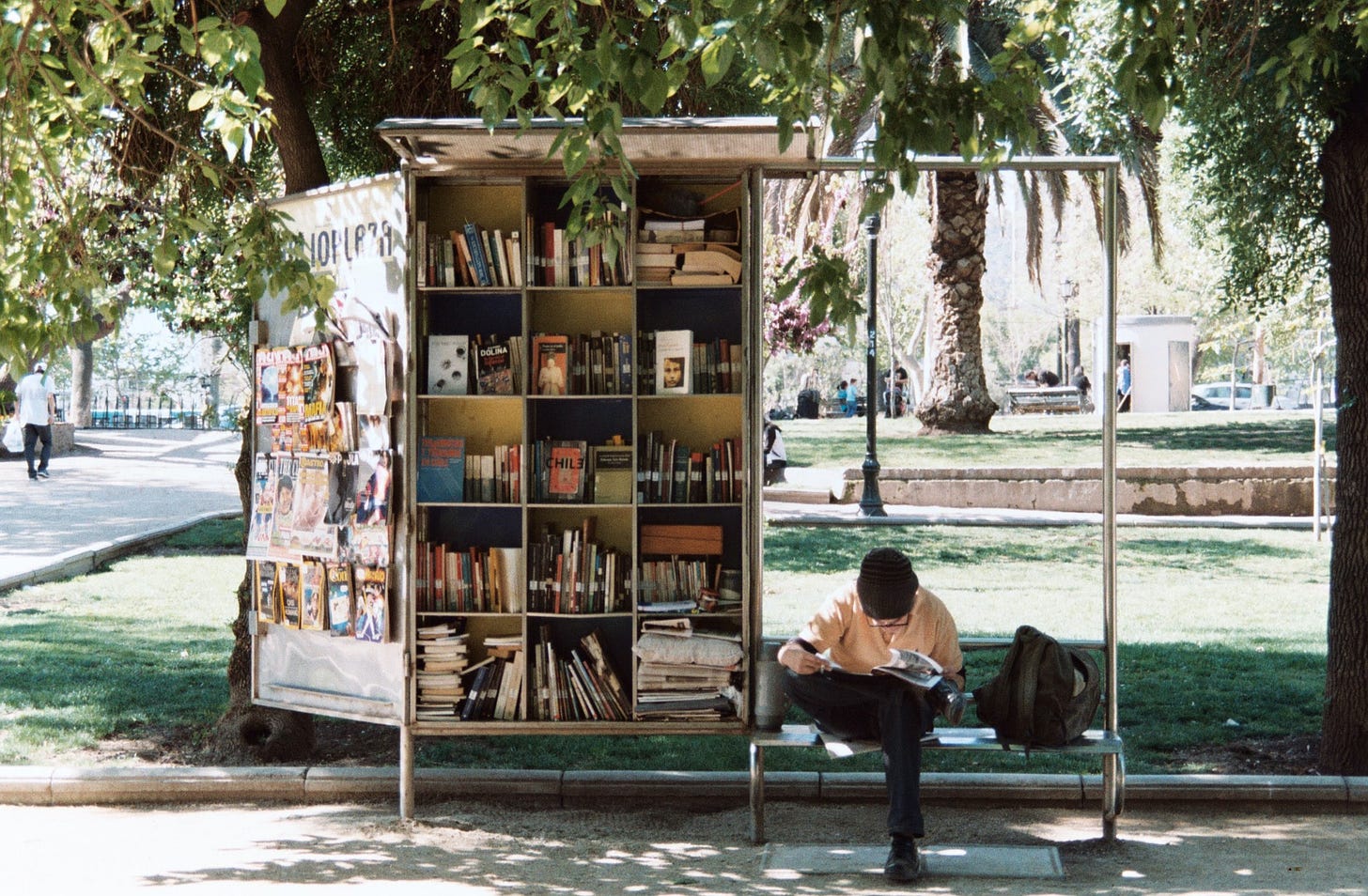 Person reading outside. Photo by L'odyssée Belle on Unsplash